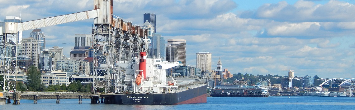 Photograph of downtown Seattle from the north, with boats and water in foreground